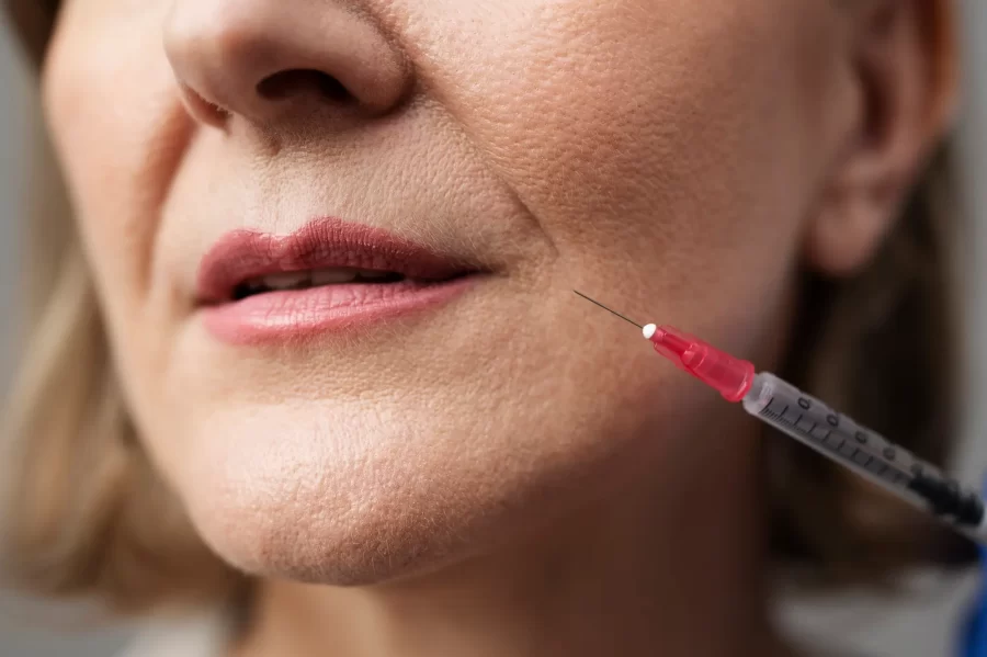 close-up-smiley-woman-with-hyaluronic-acid-injection_23-2149343882